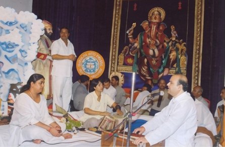Distinguished guests performing puja at the mandap